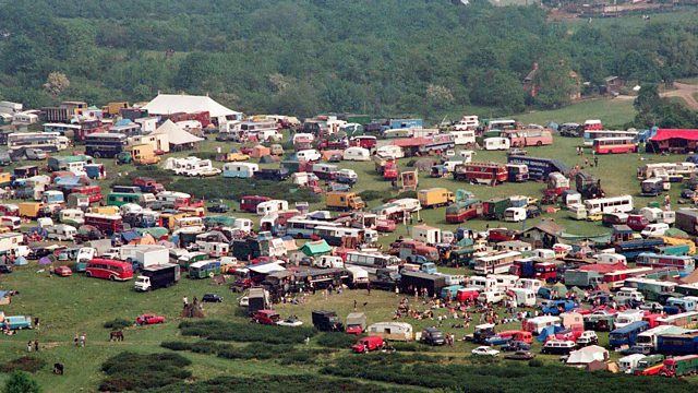 Aerial view of thousands of vehicles, tents and caravans packed across a green field, the Castlemorton Common gathering seen from above